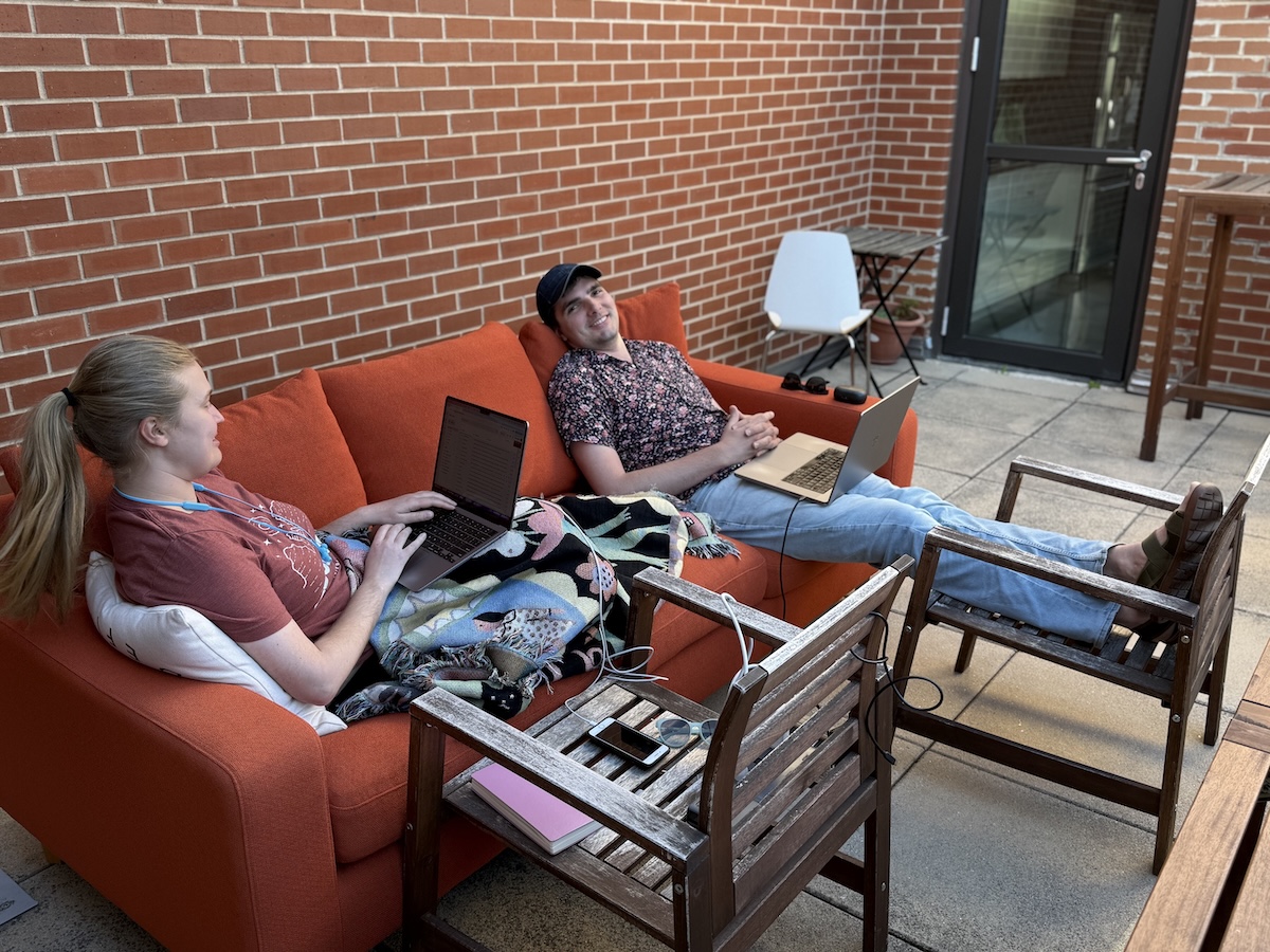 Ellory and Paul working on a couch on the patio
